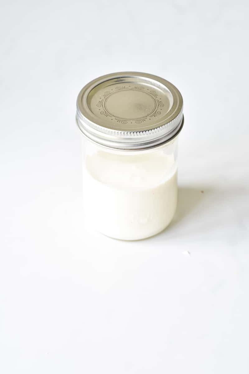 jar filled with heavy cream to make butter