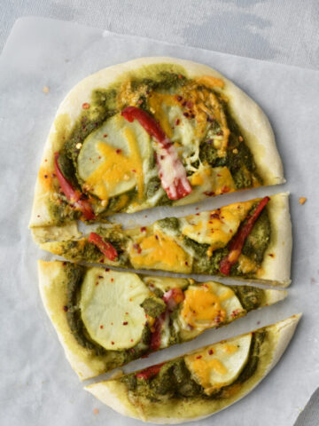 Best Pesto Pizza recipe. This Pizza has a bold spinach pesto flavors and toppes with potatoes. detailed recipe on priyascurrynation.com